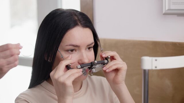 Young woman undergoing vision screening with autorefractor Ophthalmology.