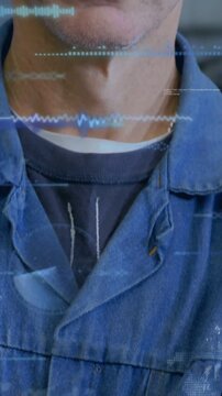 Vertical video: Cam panning up as tech filling frame wave overlay across face showing for shop data