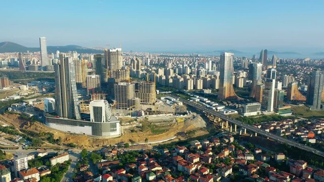 Aerial view of Istanbul Financial Center district under construction with tower cranes skyscrapers and residential neighborhood contrast in Atasehir