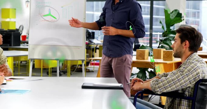 Presenter pointing at diagram in business meeting causing green icons around chart and showing plan