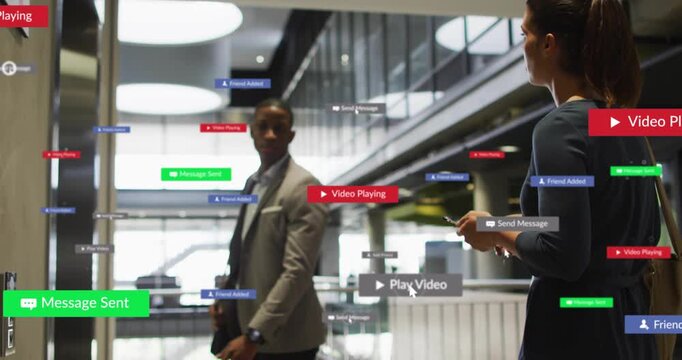 Man walking, woman tapping phone in business atrium causing play or msg badges growing then fading