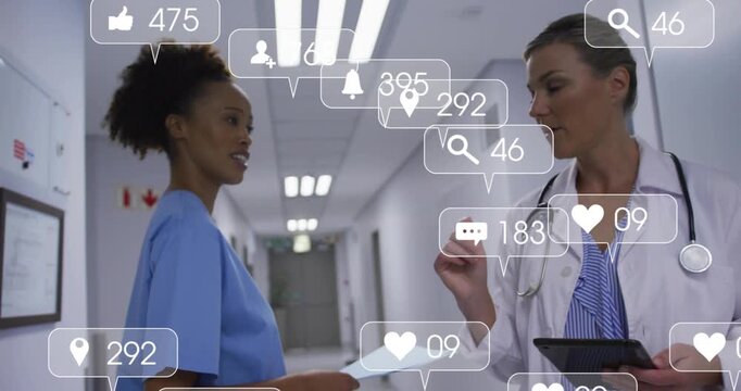 Doctor tapping tablet in medical corridor, reviewing chart as nurse presenting file, icons rising