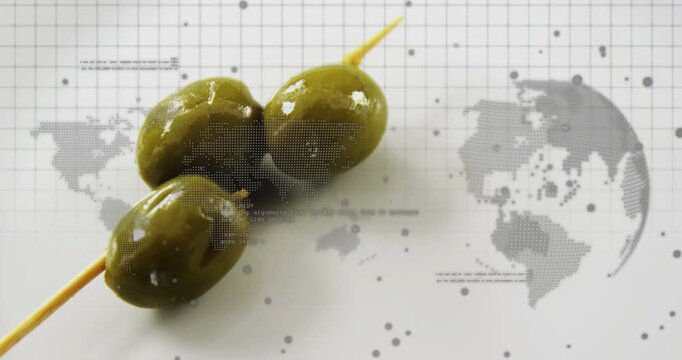 Three olives on skewer shifting as camera panning, revealing dotted globe and showing culinary grid
