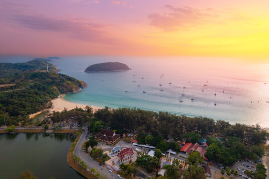 Sunset at Nai Harn, phuket: scenic aerial view of coastline and boats