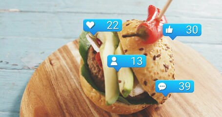 Showing single seeded slider sitting on wood board with avocado patty red pepper and blue icons © vectorfusionart