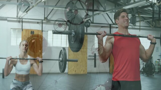 Vertical video: Male and female pair gripping barbell, lifting and pressing up for fitness