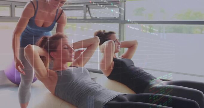 Pair starting fitness crunch on trainer cue while trainer adjusting form overlays guiding form