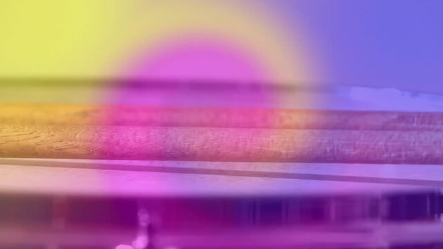 Color rings drifting and camera shifting, wooden sticks sliding right, highlighting rim reflections