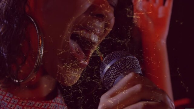 Female singer singing for music performance as camera framing lips, golden particles overlaying mic