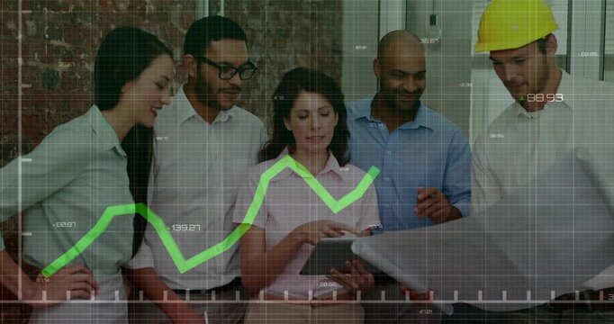 Project team tapping tablet and matching blueprint for review on site while green graph rising