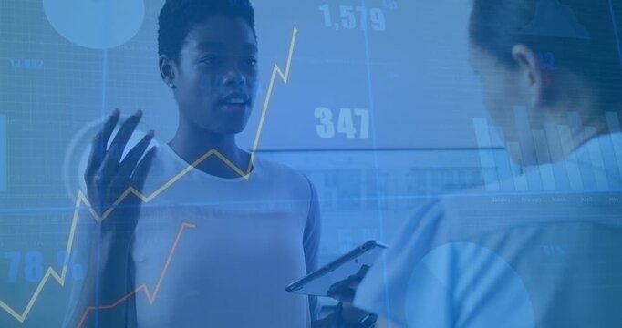 Analyst raising hand explaining business while assistant using tablet validating graphs updating