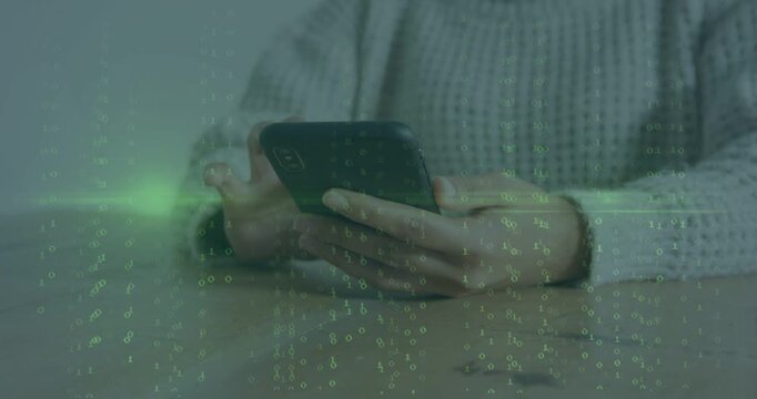 Reaching sweater-sleeved woman tapping, swiping smartphone at wood table with green matrix overlay