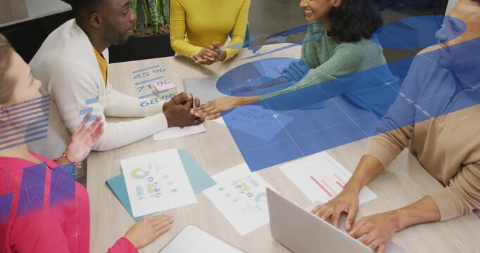 Vertical video: Business team by charts one motioning blue sweep over hands stacking hands agreeing