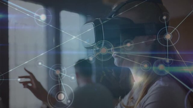 VR-headset woman extending right hand, activating virtual network, manipulating nodes to demo tech