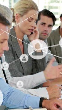 Vertical video: Manager taking phone call in office, overlay linking icons while aligning team