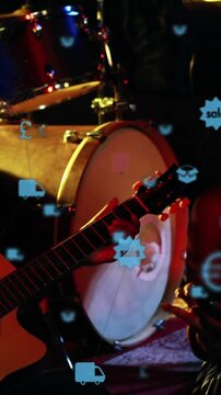Vertical video: Guitarist playing, female with phone, icons drifting across guitar promoting music