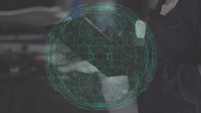 Animation of connecting dots sphere over caucasian male worker writing on pad at workshop