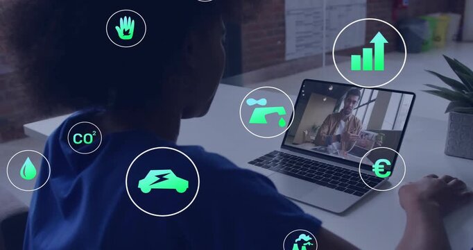 Woman initiating sustainability call on laptop, icons fading, highlighting and centering car icon