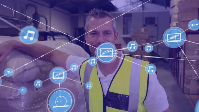 Animation of network of digital icons against caucasian male worker smiling at warehouse