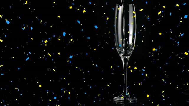 Flute filling up with champagne in slow motion against black background