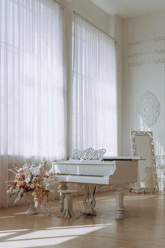 White Grand Piano in Elegant Sunlit Interior