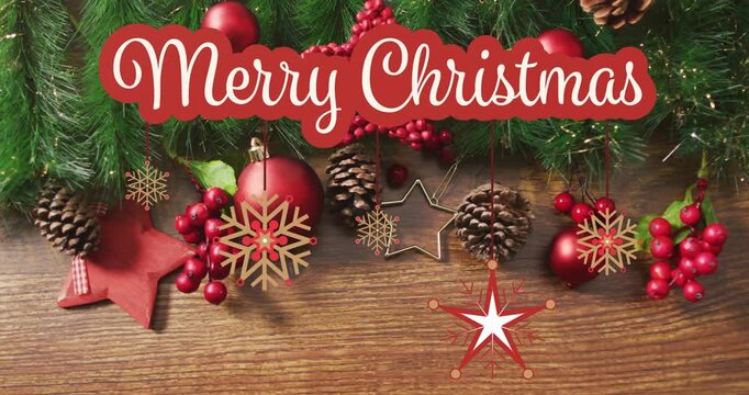 Animation of christmas greetings text over christmas decorations