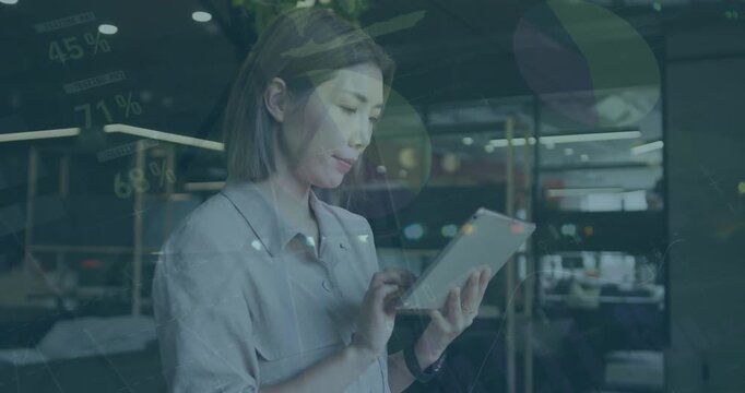 Animation of infographic interface and bokeh effect against asian businesswoman using digital tablet