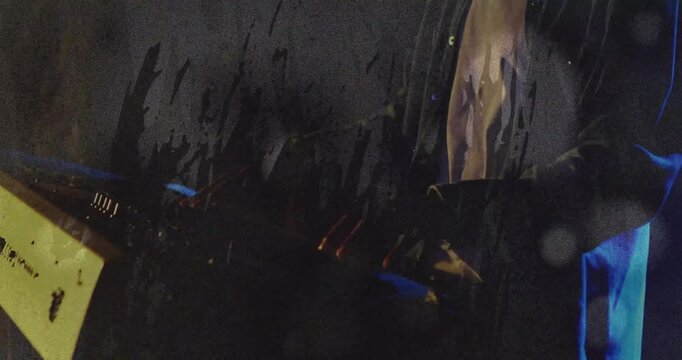 Male musician placing hands on MIDI rig and making music while glitch overlay sweeping across frame