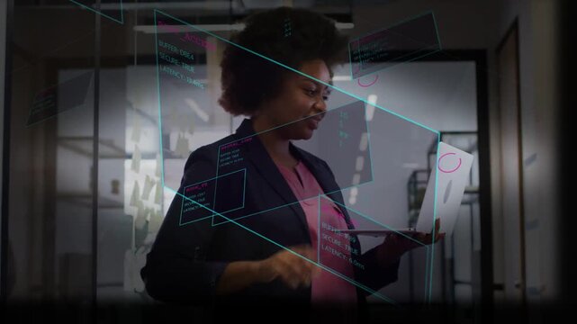 Woman typing on laptop in office, activating teal UI and progress ring, validating tech results
