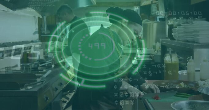 Female chef responding to HUD timer, chopping ingredients and sliding plate in commercial kitchen