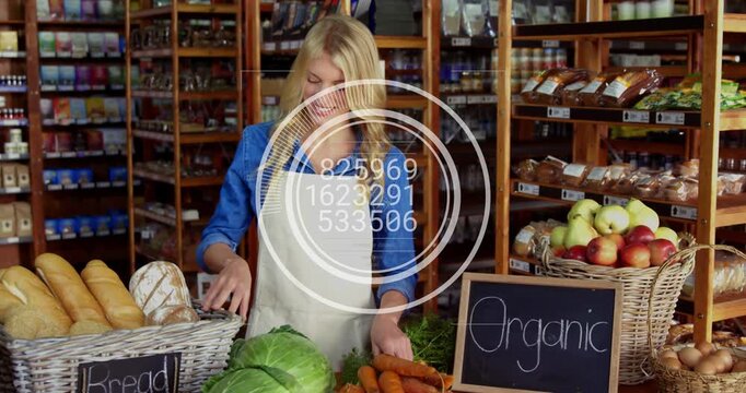 Shop clerk arranging bread and cabbage in organic shop, reaching basket causing HUD showing bread