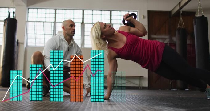 Woman holding side plank pressing kettlebell on coach cue coach logging gym data as charts growing