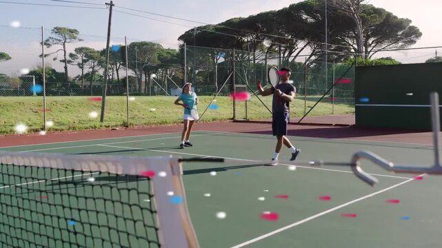 Tennis pair practicing rally at net, woman stepping to hit, confetti floating around players