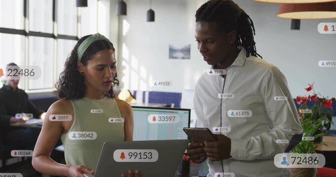 Pair reviewing laptop and tapping phone for business tapping starting label overlays growing counts