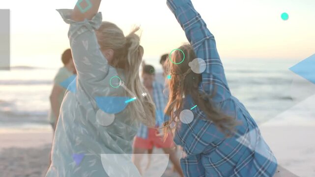 Vertical video: Spinning two women leading group on shore at sunset showing bikini and sea overlays