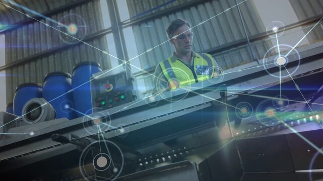 Male technician tapping panel and inspecting plant conveyor, overlay nodes mapping system health