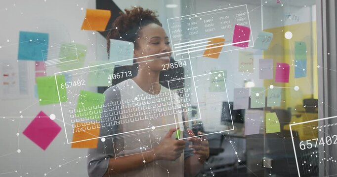 Mid-adult woman holding marker and adjusting sticky notes as overlay appearing for product planning
