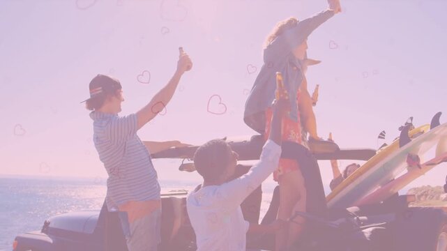 Five travelers raising bottles causing hearts drifting across sky steadying pal on rollbar by coast