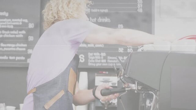 Male barista locking portafilter and operating espresso machine dispensing coffee for client order