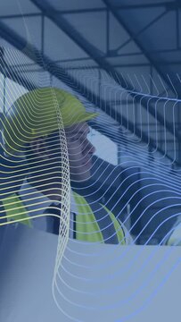 Vertical video: Site manager holding blueprint reading plans, grid sweeping across causing review