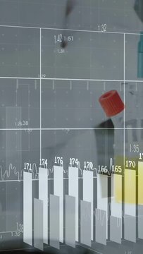 Vertical video: Senior lab tech reaching handle opening vials pipetting samples, charting results