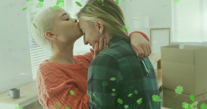 Vertical video: Woman in orange touching partner, kissing forehead moving, green overlay over faces