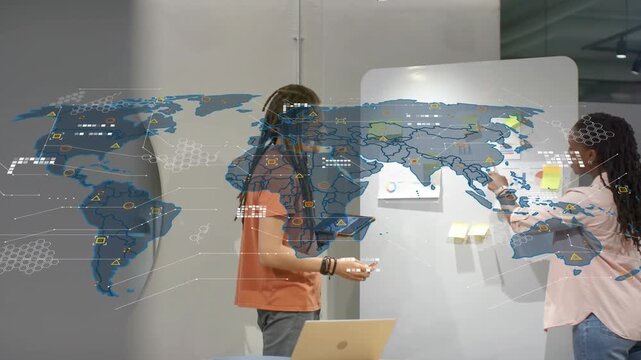 Vertical video: Woman placing notes, man with tablet moving, map rising over board guiding business