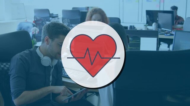 Animation of heart icon over diverse business people talking in office