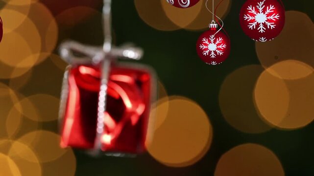 Animation of snow falling over christmas presents and decoration