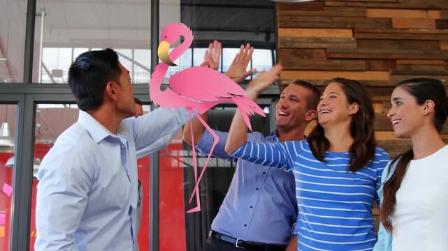 Animation of flamingo over multiracial coworkers happy and giving high fives after getting project
