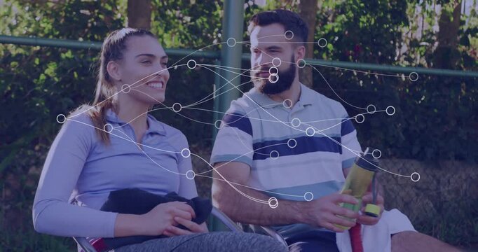 Sitting outdoors, couple smiling with network connections animation overlay