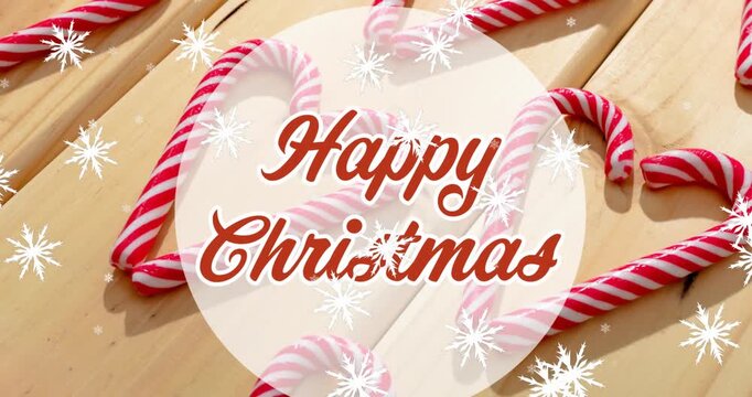 Animation of christmas greetings text over christmas candy canes decorations and snow