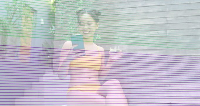 Woman sitting poolside with phone, scrolling and sipping while scanline obscuring view showing tech