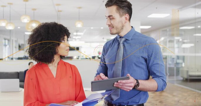 Man with tablet tapping to show content, woman with binder comparing papers, reconciling documents